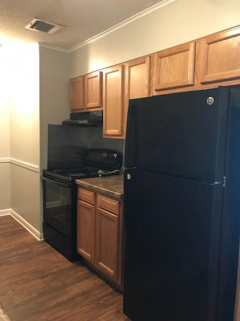 Apartment kitchen with black refigerator and stove