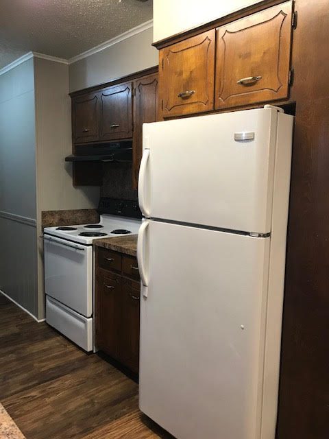 Apartment kitchen with white refigerator and stove